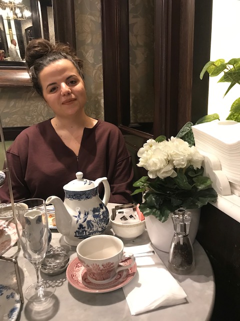 A woman poses for a pic at afternoon tea